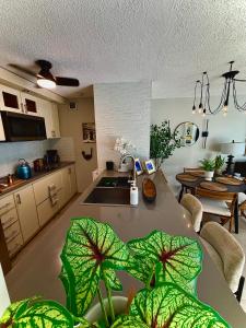 a kitchen with a sink and a table with plants at Stylish Designed 1BR Coral Beach by Stay Here PR in San Juan