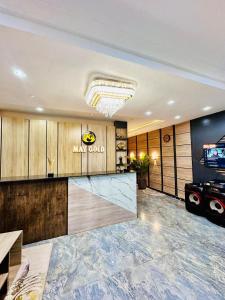 a hotel lobby with a bar and a television at May Gold Luxury Apartments in Benin City