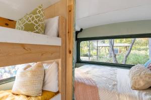 a room with two bunk beds and a window at Magic Bus on river w/hot tub at Smuggler's Notch in Morses Mill
