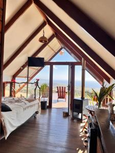 a bedroom with a bed and a view of the ocean at Terevaka Lodge Rapa Nui in Hanga Roa