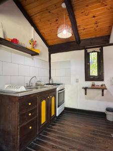 a kitchen with a sink and a stove at Galilea in San Miguel del Monte