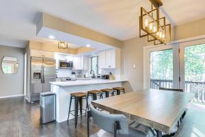 a kitchen and dining room with a table and chairs at 6 Mi to Bushkill Falls Secluded Home with Game Room in Saw Creek