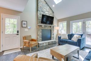 a living room with a fireplace and a tv at 6 Mi to Bushkill Falls Secluded Home with Game Room in Saw Creek