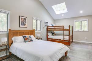 a bedroom with two bunk beds and two windows at 6 Mi to Bushkill Falls Secluded Home with Game Room in Saw Creek