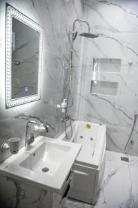 a white bathroom with a sink and a mirror at lotus view El tahrir in Cairo +34 photos