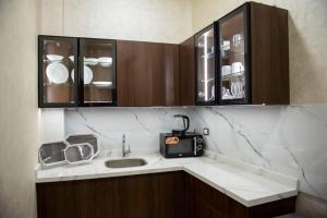 a kitchen with a sink and a microwave at lotus view El tahrir in Cairo