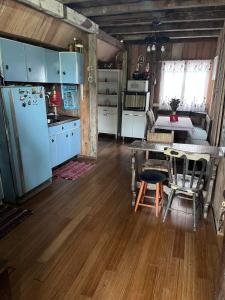 a kitchen and dining room with a table and refrigerator at Chalé do lago in Campo Alegre +12 photos