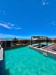 a large swimming pool on top of a building at Comfort and elegance in the heart of Cabo Branco in João Pessoa