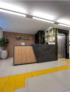 a lobby with a x intercept sign on the wall at West Fit Padrão 05 in Mossoró