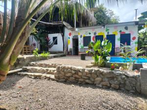 a house with a stone wall in front of it at Casa sol palomino in Palomino