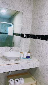 a bathroom with a sink and a mirror and towels at Apartamento com ótima localização! in Belém