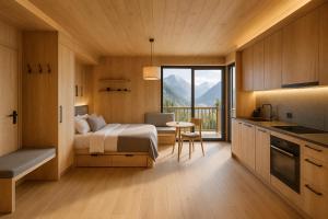 a bedroom with a bed and a table and a kitchen at Neues Alpenstudio in Schladming in Rohrmoos