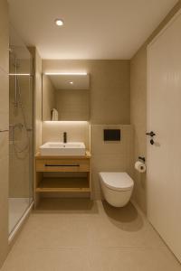 a bathroom with a sink and a toilet and a shower at Neues Alpenstudio in Schladming in Rohrmoos