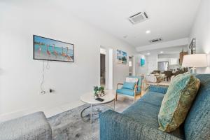 a living room with a couch and a table at Arubas Life 108 in Noord