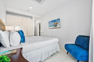 a bedroom with a bed and a blue couch at Arubas Life 108 in Noord +60 photos