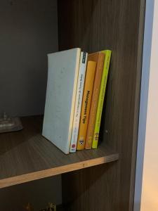 a group of books sitting on a shelf at Chambre climatisée , wifi , serviettes, café ou thé offert in Dakar