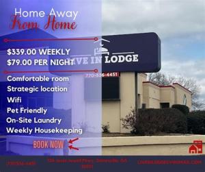 a sign in front of a home away from home at Live in Lodge in Gainesville