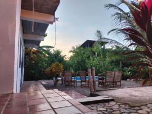 a patio with chairs and a table near a pool at Casa sol palomino in Palomino
