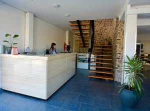 a woman is sitting at a counter in a room at Hotel Montecarlo PSH in Villa Carlos Paz +48 photos