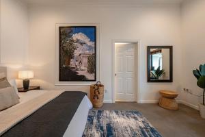 a bedroom with a bed and a painting on the wall at Gorgeous Grand 1000m2 Villa - 5BR with pool in D2 by Ray 02 in Ho Chi Minh City +99 photos