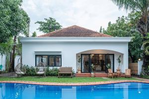 a house with a swimming pool in front of it at Gorgeous Grand 1000m2 Villa - 5BR with pool in D2 by Ray 02 in Ho Chi Minh City