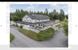 an aerial view of a large white house at Hotell Heia-Elverum-Flisa-Våler i Solør in Våler i Solør