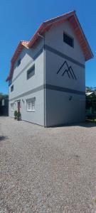 a large white building with a red roof at Suite Negri in Canela +11 photos