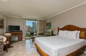 a hotel room with a bed and a television at Luana Waikiki in Honolulu +59 photos