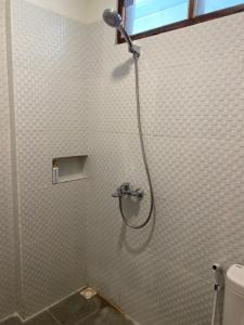 a shower in a bathroom with a shower at Mango Room Mandalika in Kuta Lombok +31 photos