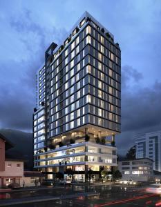 a tall building with a lot of windows at Sense Coliving Ecuador Residences & Convention in Quito