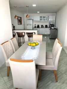 a kitchen with a table with a bowl of fruit on it at Aconchego do sertão in Piranhas