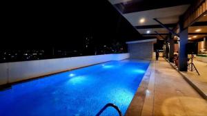 a large swimming pool in a building at night at Jtower residences in Mandaue City +4 photos
