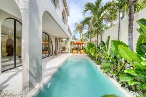 an indoor pool in a house with palm trees at Parisian Brand New Luxury Villa 8mins walk to Beach in Bingin Beach