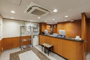a large room with a counter and a refrigerator at Nagoya Sakae Green Hotel in Nagoya