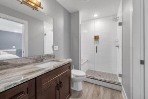 a bathroom with a sink and a toilet and a shower at Cozy Birmingham Retreat in Birmingham +23 photos