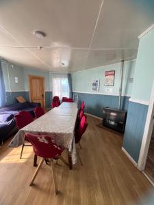 a room with a table and chairs and a bed at Casas Punta Arenas in Punta Arenas