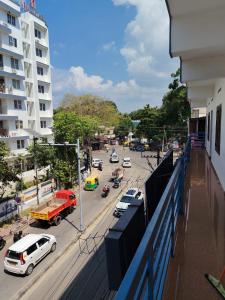 a view of a city street with cars and trucks at Vidara Budget Stay in Trivandrum