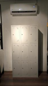 a row of lockers in a room with a ceiling at Chalok Hostel in Koh Tao