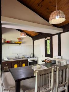 a kitchen with a table and two chairs in it at Galilea in San Miguel del Monte