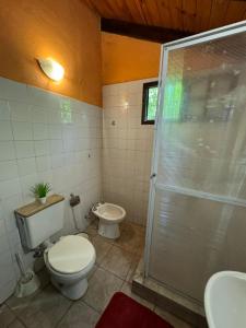 a bathroom with a toilet and a shower at Galilea in San Miguel del Monte +15 photos
