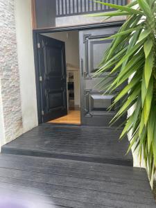 an open door to a house with a plant at scarborough QLD private accommodation E in Redcliffe