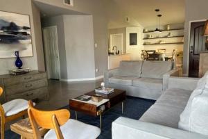 a living room with a couch and a table at 5 minute walk to the gulf course in San Antonio