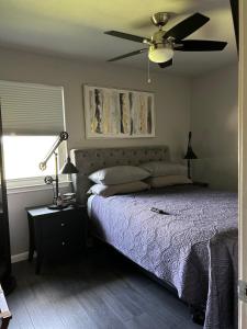 a bedroom with a bed and a ceiling fan at 5 minute walk to the gulf course in San Antonio