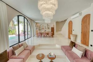 a living room with pink couches and a dining room at Parisian New 2BR Luxury Villa 8mins walk to Beach in Bingin Beach