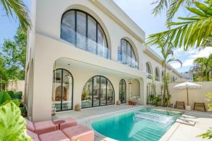 an exterior view of a house with a swimming pool at Parisian New 2BR Luxury Villa 8mins walk to Beach in Bingin Beach