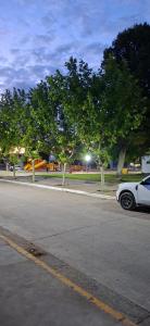 a white car parked on the side of a street at Apart Brumato in Catriel