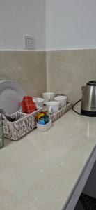 a counter with several bowls on top of a counter at Apart Brumato in Catriel