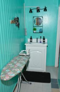 a blue bathroom with a sink and a table at South Oasis in Georgetown
