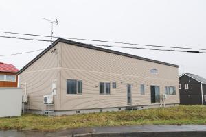 a large building with a house at La Neige in Makkari