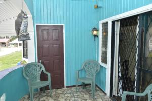 two chairs on the front porch of a house at South Oasis in Georgetown